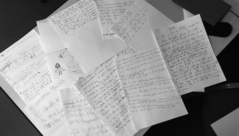 Textes manuscrits d'élèves étalés sur une table